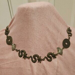 NECKLACE, FANS AND SNAKES IN AN "EAST MEETS WEST" STATEMENT PIECE